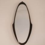 Mid-Century wall mirror — full view showing elongated sculptural silhouette
