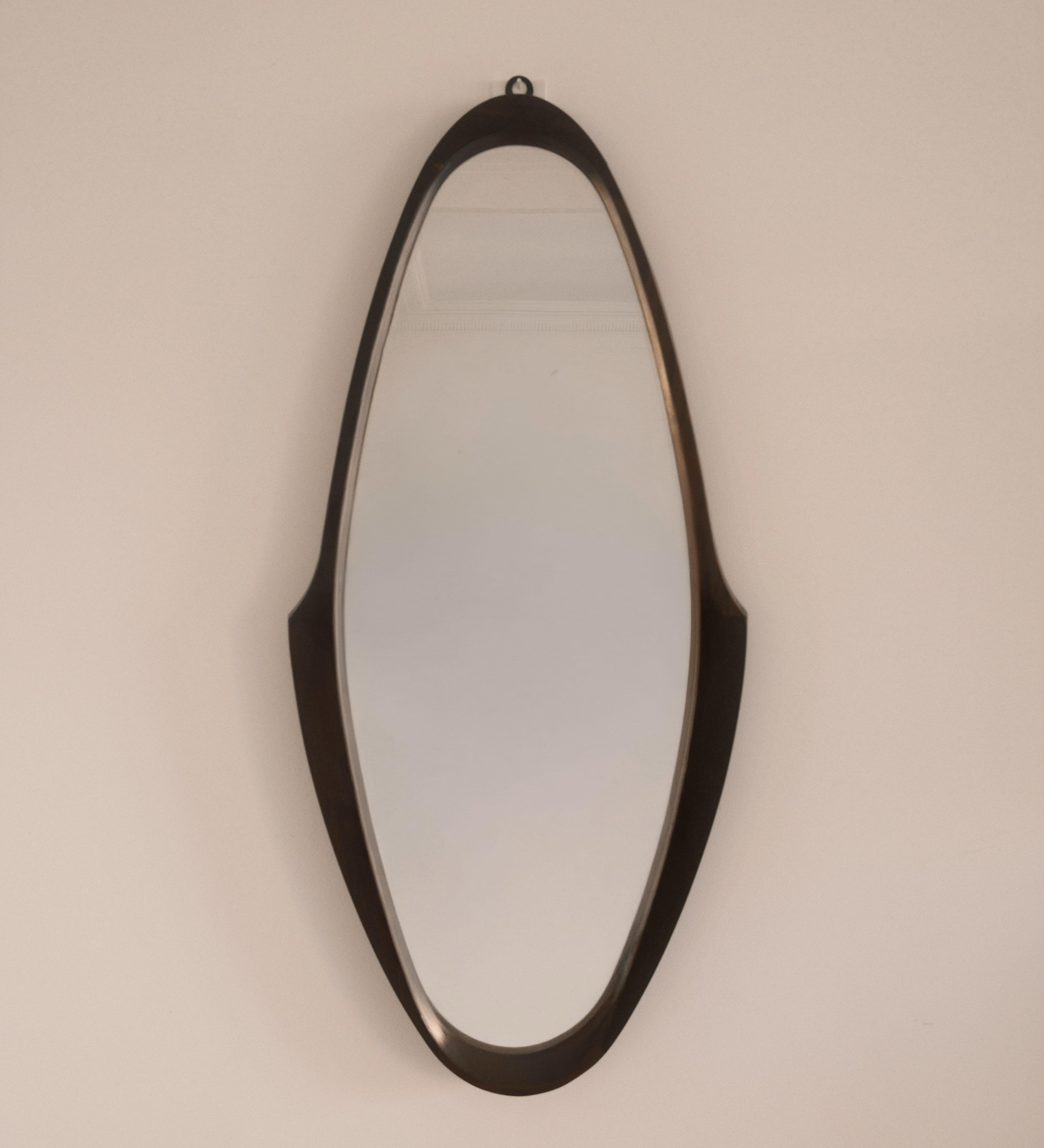 Mid-Century wall mirror — full view showing elongated sculptural silhouette