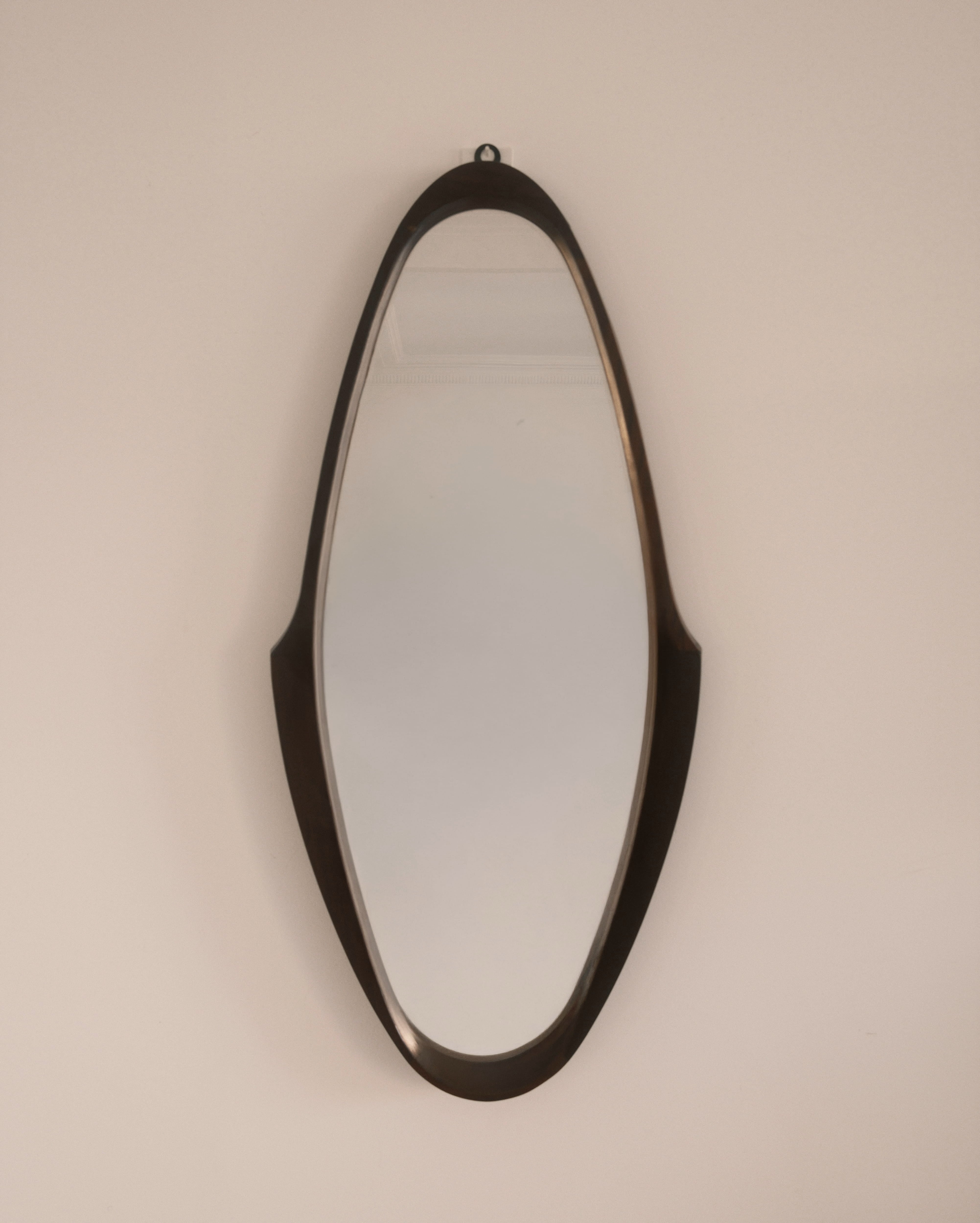 Mid-Century wall mirror — full view showing elongated sculptural silhouette
