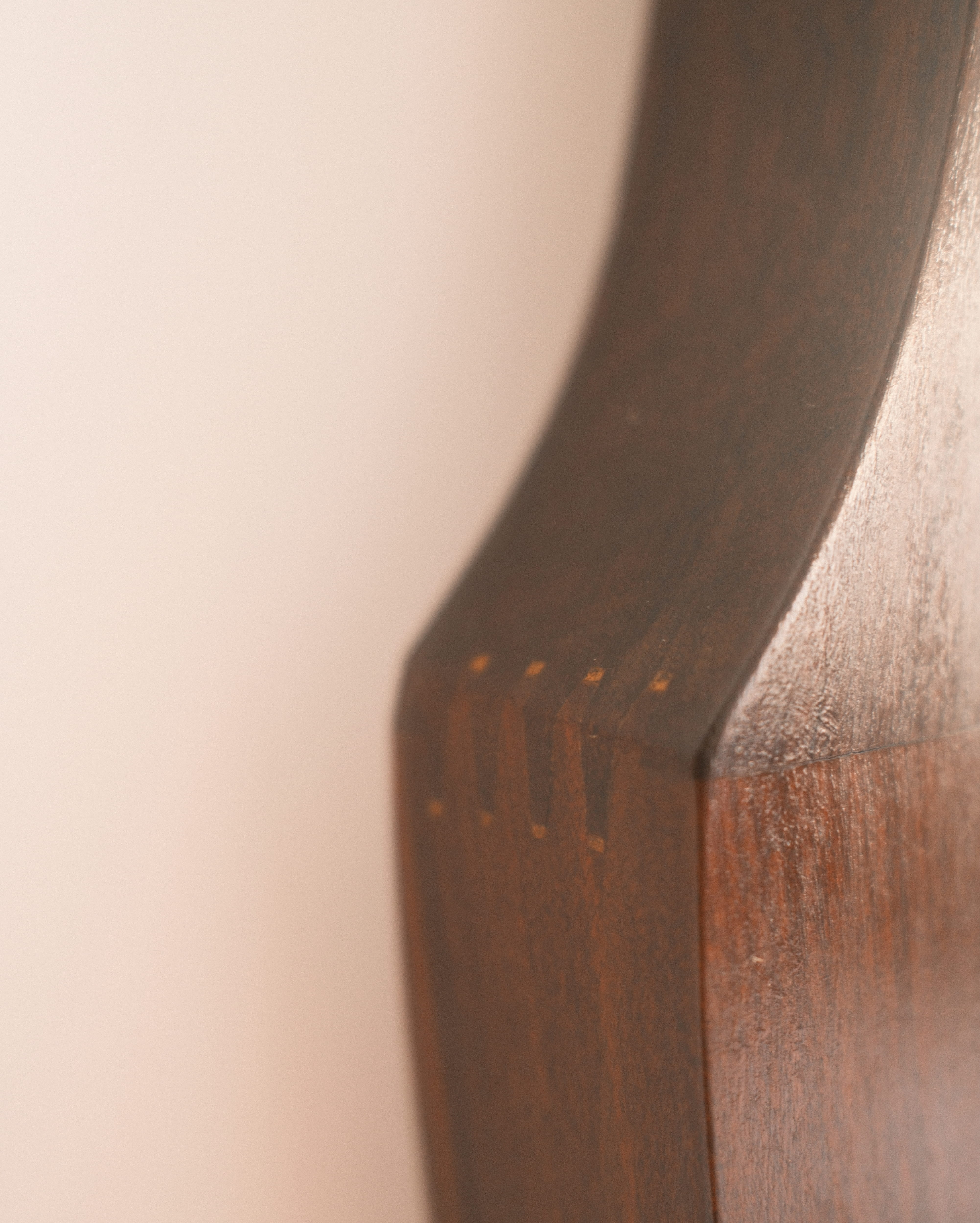 Mid-Century wall mirror — close-up of shaped teak edge and grain