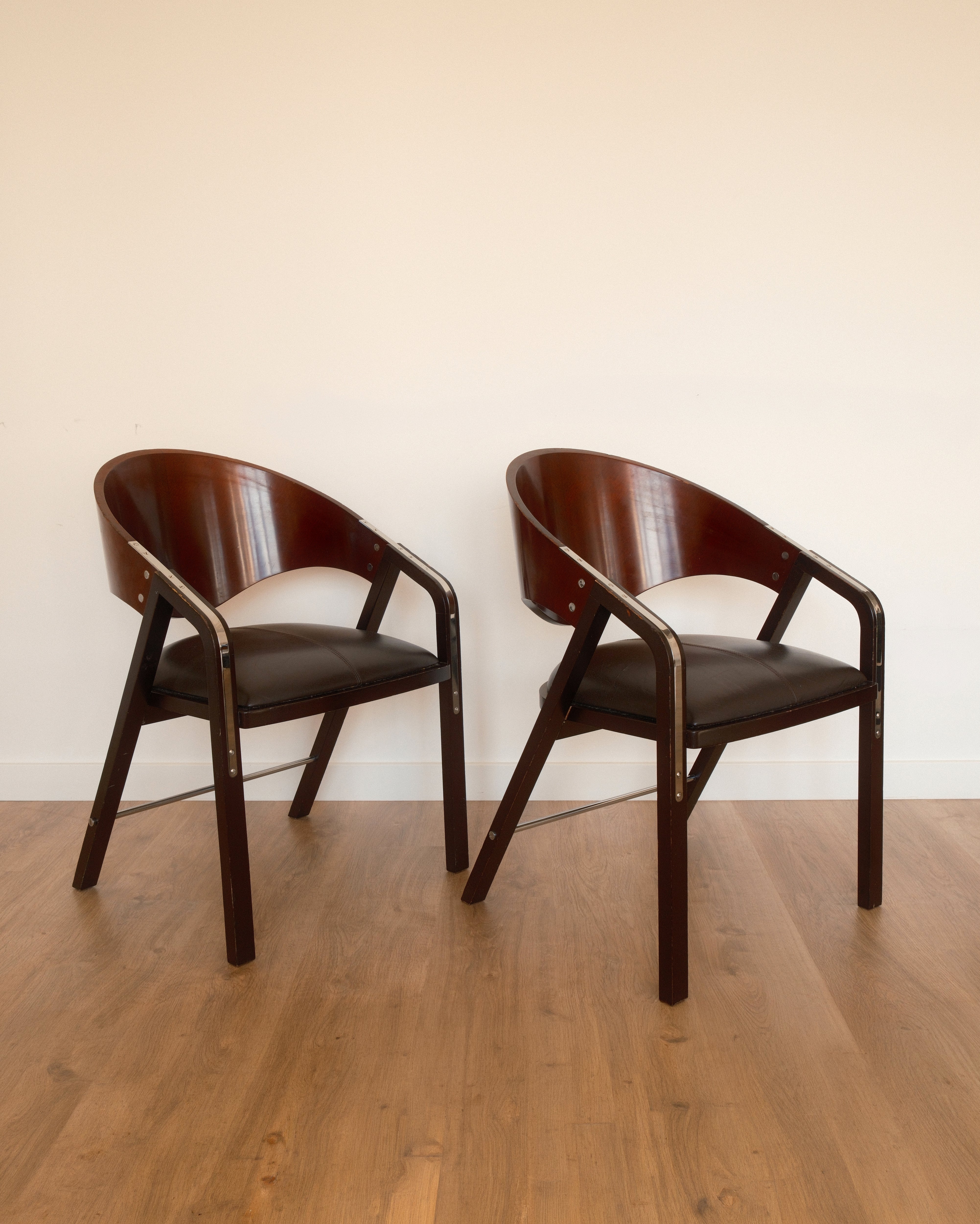 Jaume Tresserra Spinnaker armchairs — dark walnut and black faux leather, Spain, c. 1990s