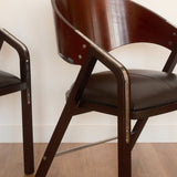 Jaume Tresserra Spinnaker armchairs — angled front view highlighting crescent-shaped backrest