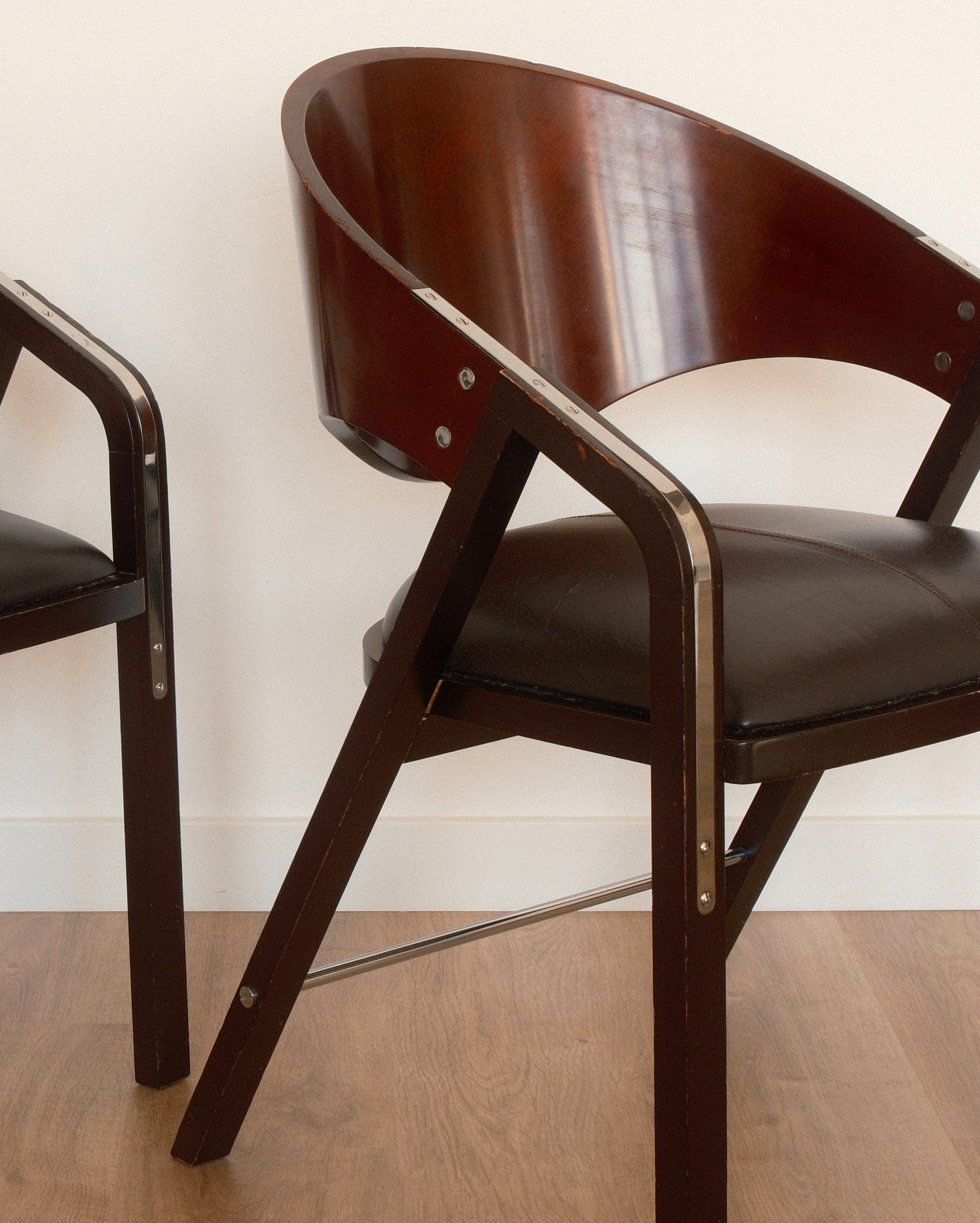 Jaume Tresserra Spinnaker armchairs — angled front view highlighting crescent-shaped backrest