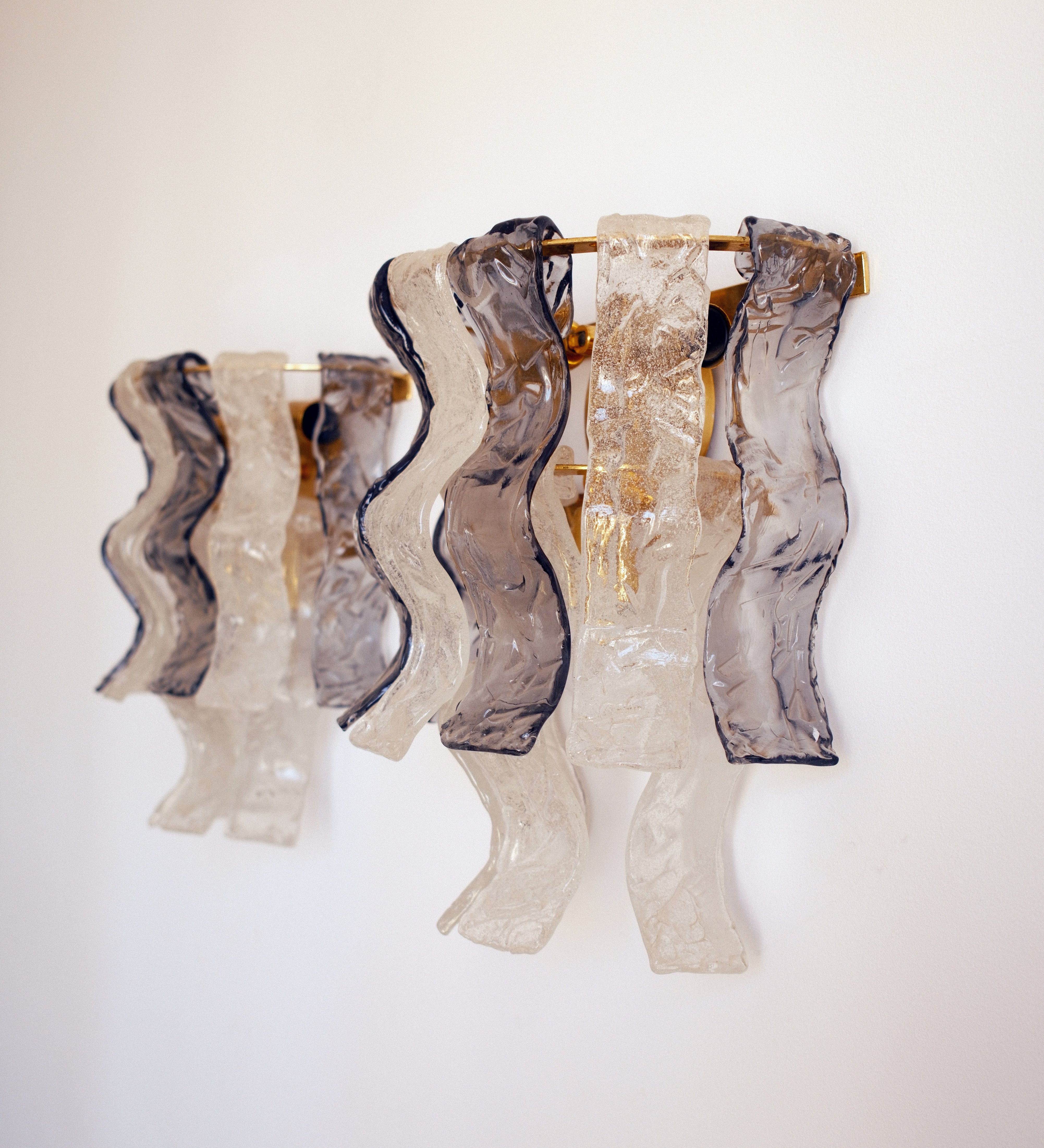 Murano glass wall lights — pair view showing sculptural wavy glass panels