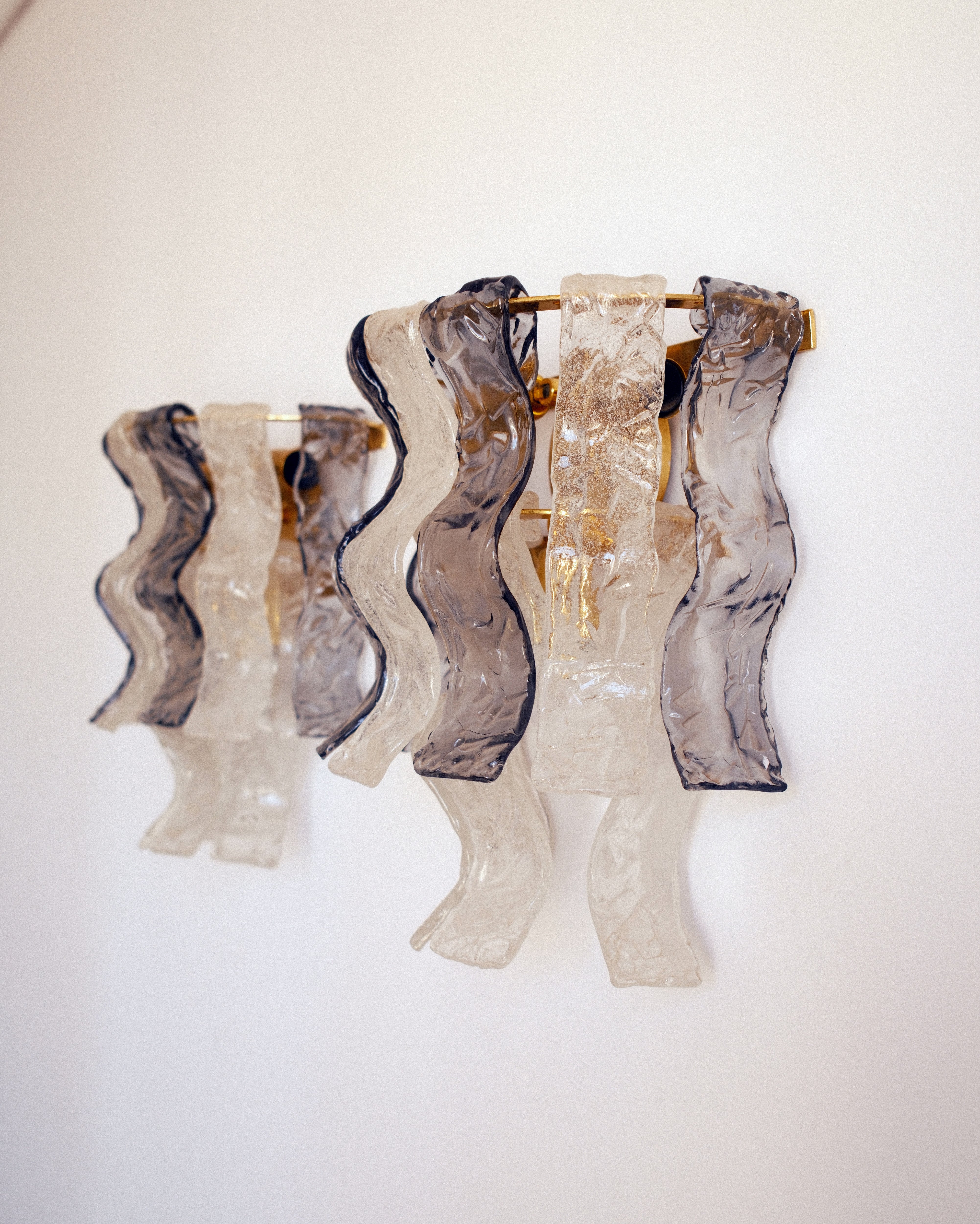 Murano glass wall lights — pair view showing sculptural wavy glass panels